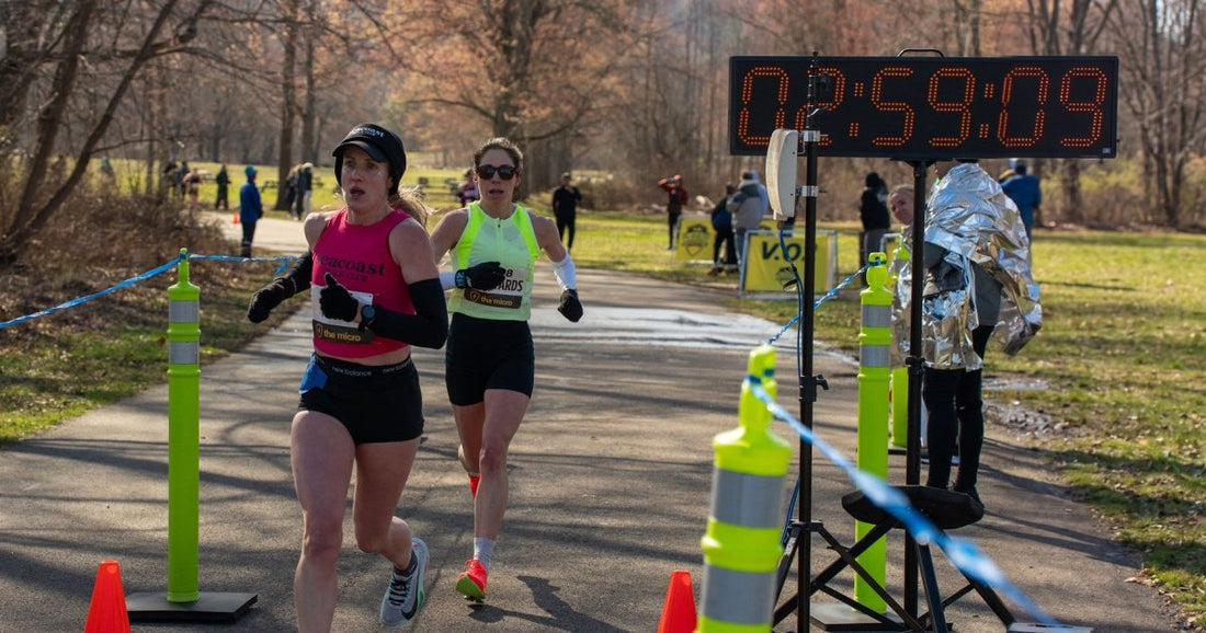 Two Breaking 3 finishers approach the line at Rockland Lake as the race clock reads 2:59:09