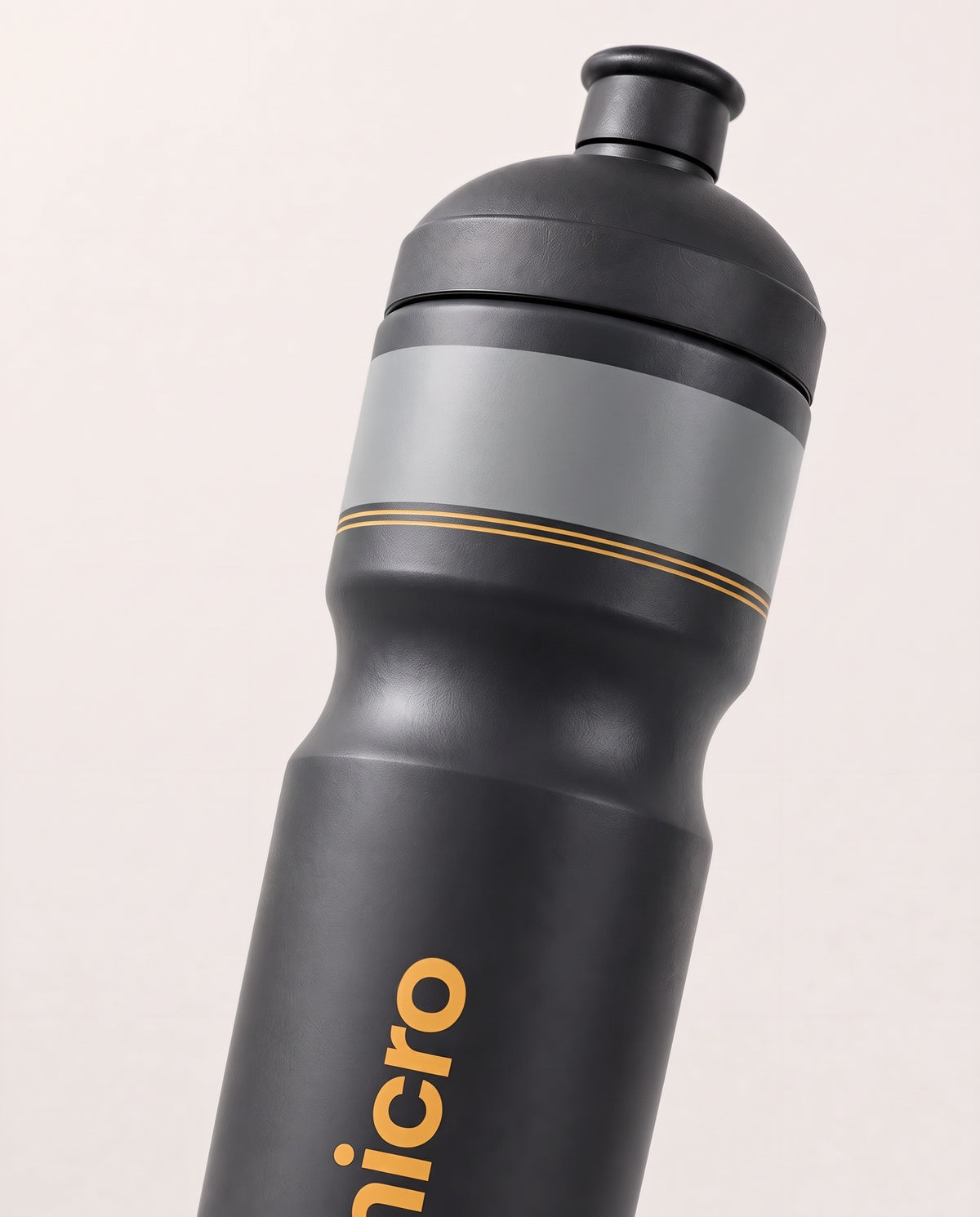 Close-up of The Micro race bottle gray band and yellow pinstripes