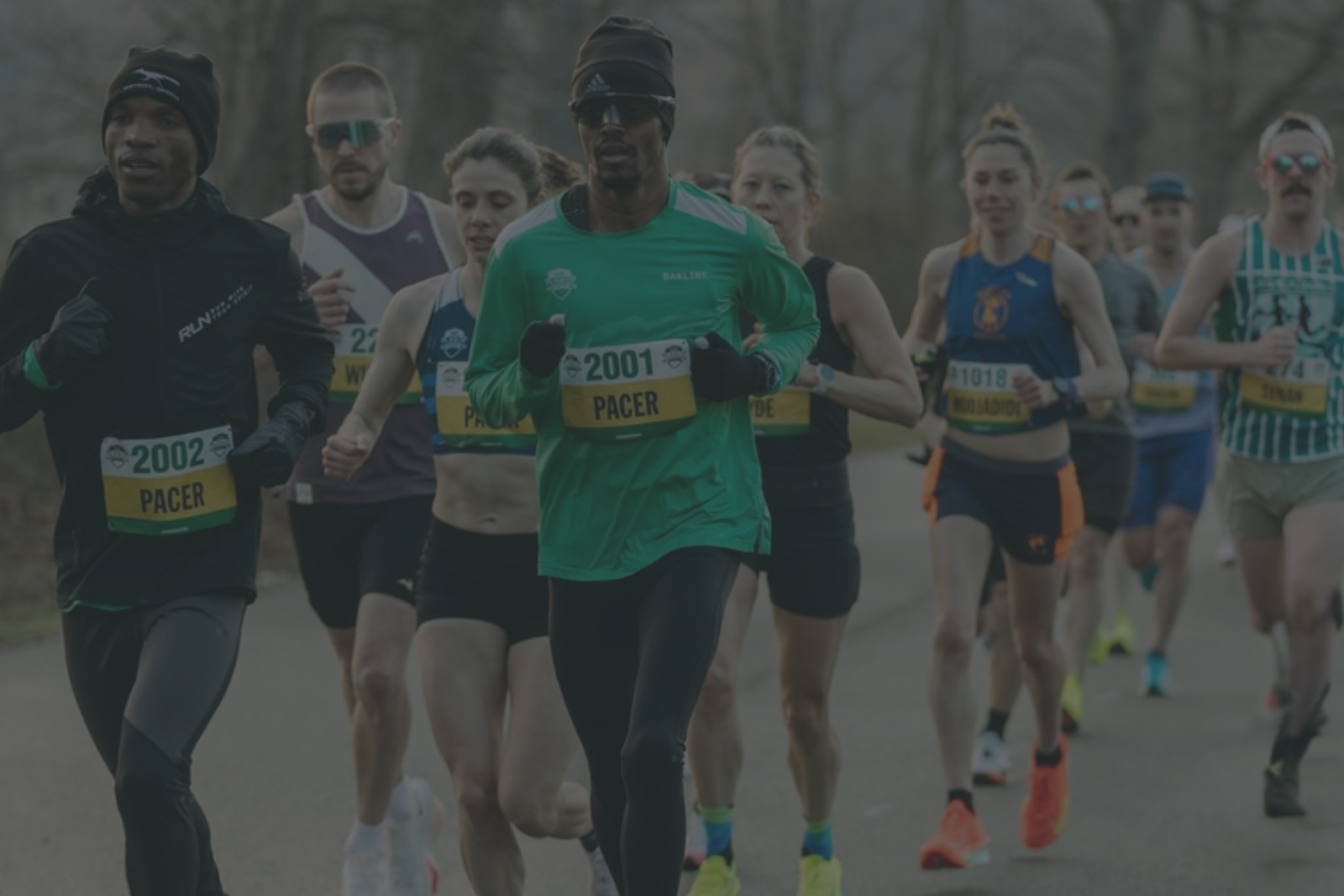 Runners participating in a race with visible race numbers on bibs.